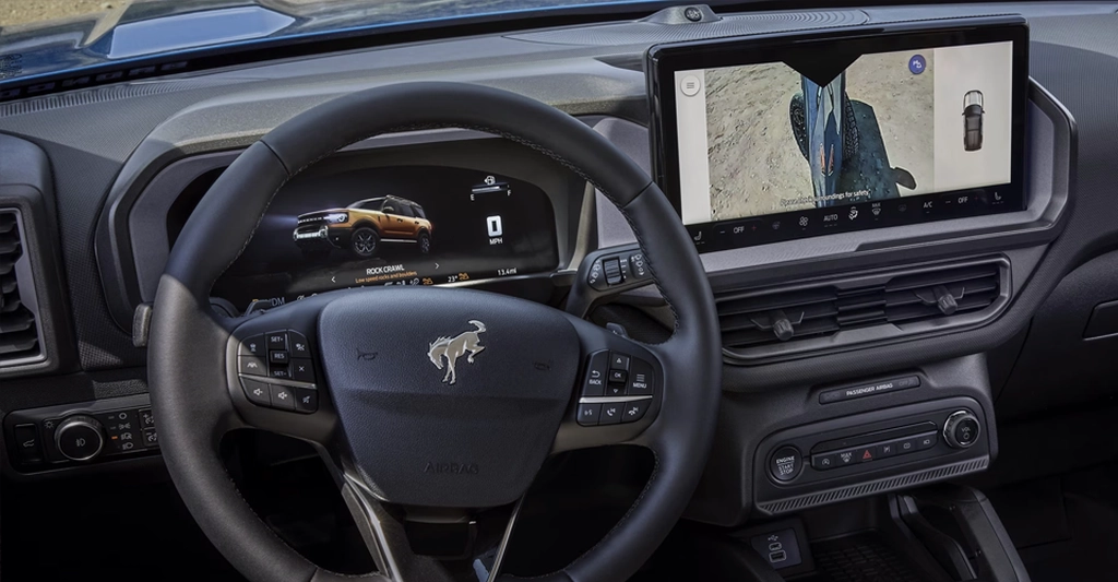 A detailed shot of the interior of a Ford Bronco, focusing on the dashboard and steering wheel.