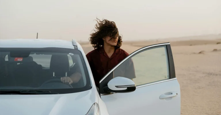 A medium shot captures a 25-year-old Middle Eastern women with light brown skin, standing next to a white car