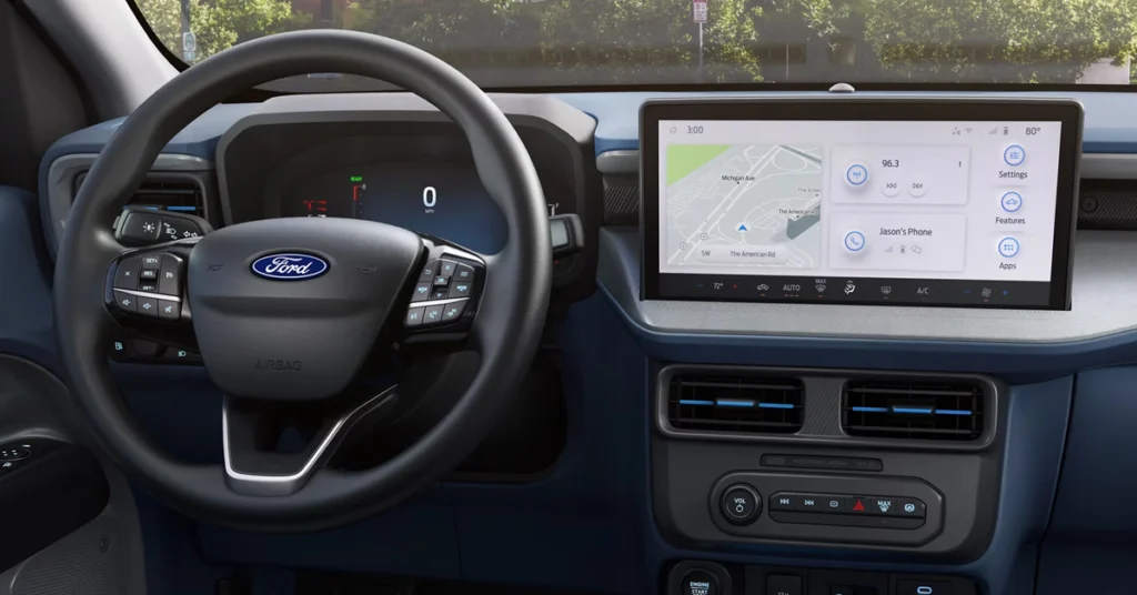 Steering wheel and 2025 Ford Maverick Hybrid Lariat dashboard of a modern car interior. A large digital display shows a map and controls, conveying a sleek and high-tech ambience.
