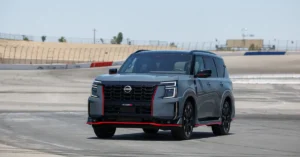 A 2026 Nissan Armada driving on a racetrack, showcasing its sleek design and powerful performance.