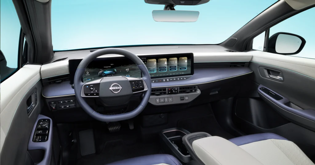 New 2026 Nissan LEAF interior with a sleek, futuristic dashboard featuring a large, high-tech touchscreen. Blue accents provide a clean, sophisticated feel.