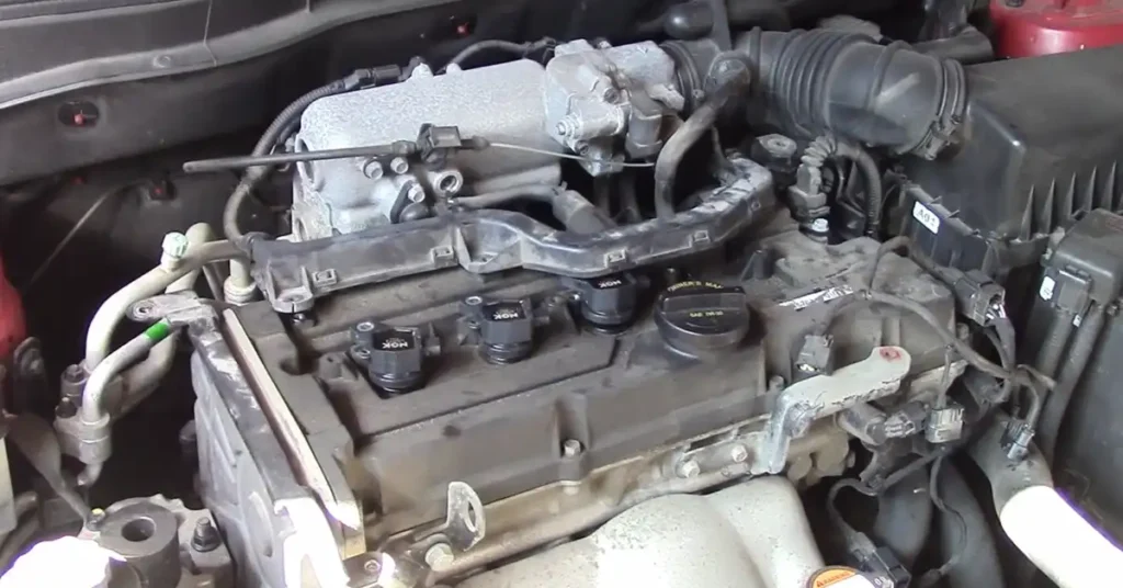 Engine bay of a Hyundai Accent showing the location of the four ignition coil
