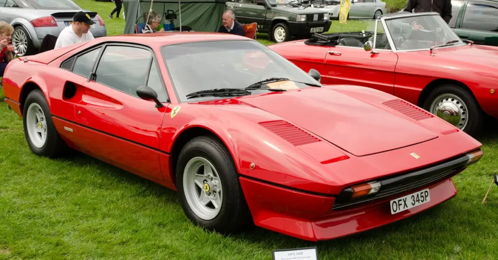 Ferrari 308 GT3 showcased at the Goodwood Festival of Speed, surrounded by spectators and classic cars.