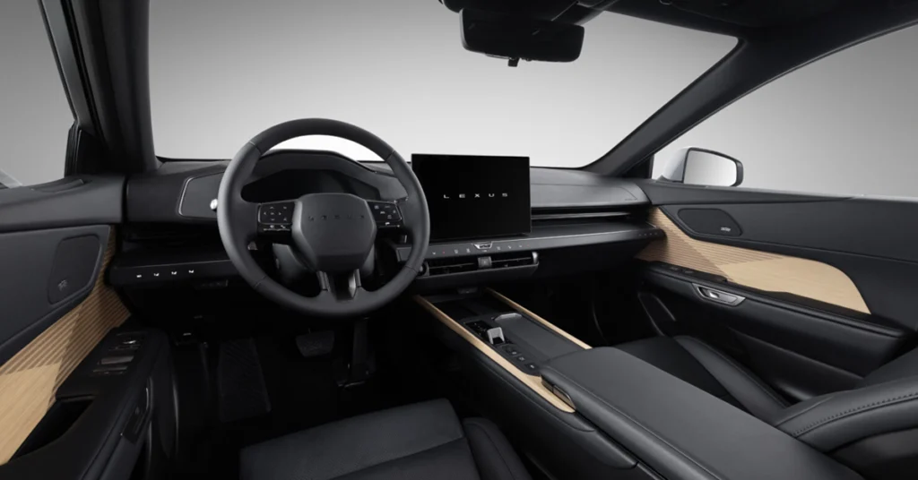 Interior of a2026 Lexus ES , showcasing the dashboard, steering wheel, and seats, with a modern and minimalist design, featuring a large central display screen with the word "LEXUS" on it, black leather upholstery with light wood trim accents, and a clean, uncluttered layout.