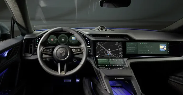 Interior of a Porsche Cayenne, showing the dashboard, steering wheel, and infotainment screens, the dashboard is sleek and modern, with a minimalist design, the steering wheel is leather-wrapped and features the Porsche crest, the infotainment screens are large and high-resolution, displaying navigation, music, and other vehicle information, the overall aesthetic is luxurious and high-tech, with a focus on driver experience and connectivity.