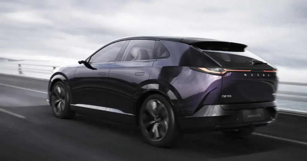A sleek, dark purple Mazda EZ-60 electric vehicle is captured in motion from a low, rear three-quarter perspective.