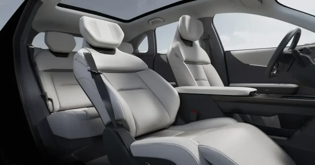 Interior of a Interior of a Mazda EZ-60 , featuring a minimalist design with a focus on technology and comfort. The dashboard is dominated by a large, wide-screen display that spans the majority of the console, showing a car image. with white leather seats, black dashboard and a sunroof.