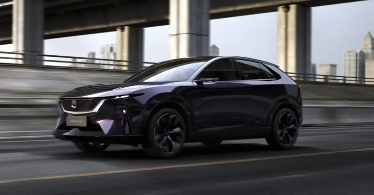A sleek, dark purple Mazda EZ-60 electric SUV is captured in motion on a highway, with a blurred cityscape in the background.