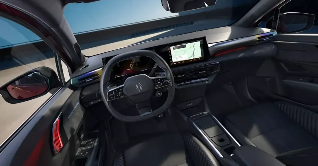 Interior of a Renault Clio 2025 car, showing the dashboard, steering wheel, and seats, with a navigation screen displaying a map. The interior is predominantly black with silver accents, and the dashboard features a modern design with digital displays.