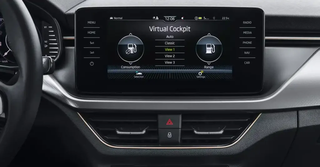 A close-up, eye-level shot shows the interior of a Skoda Kamiq SUV dashboard, focusing on the digital display and surrounding controls. The central element is a large, rectangular touchscreen displaying the "Virtual Cockpit" interface.