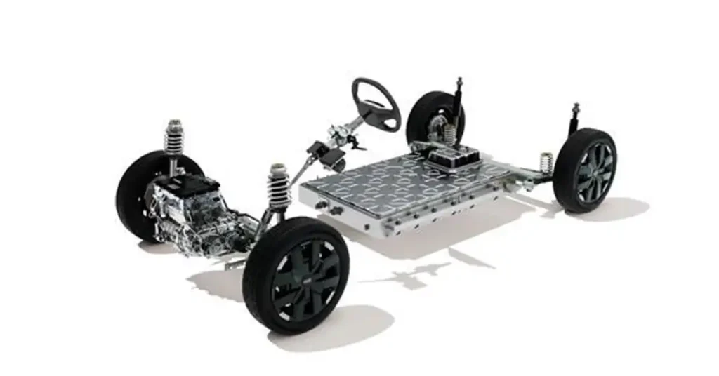 A detailed, high-angle, studio shot showcases the chassis of an 2026 Dacia Spring electric car against a stark white background. The chassis is presented as a cutaway, revealing its internal components. At the center, a large, flat, rectangular battery pack with a textured, metallic surface is prominently displayed.