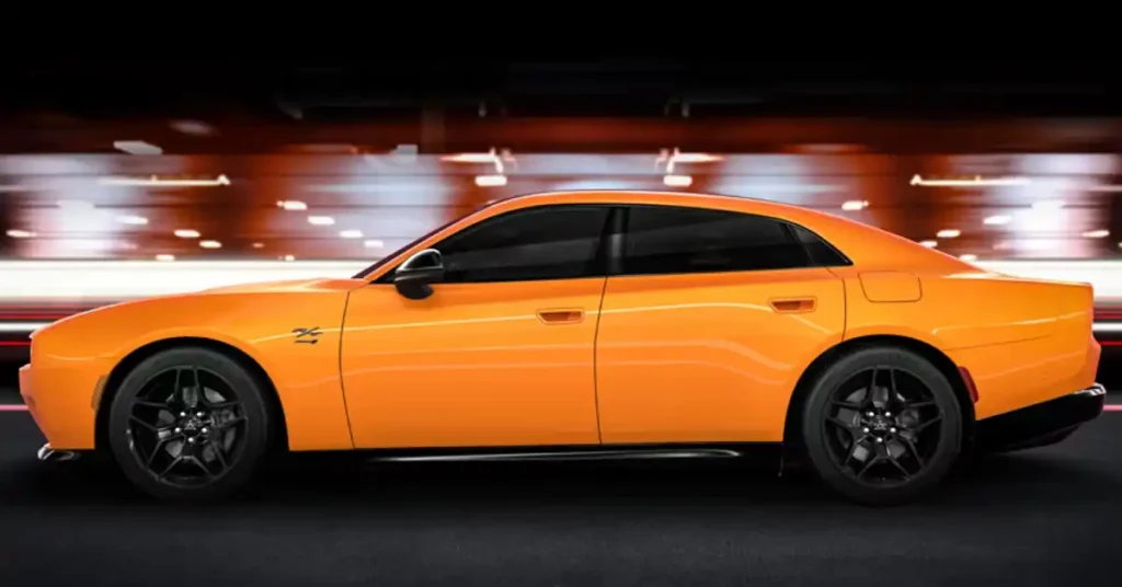 A side profile of an orange 2026 Dodge Charger Daytona sedan is captured in motion, with the car's sleek lines and black rims conveying a sense of speed