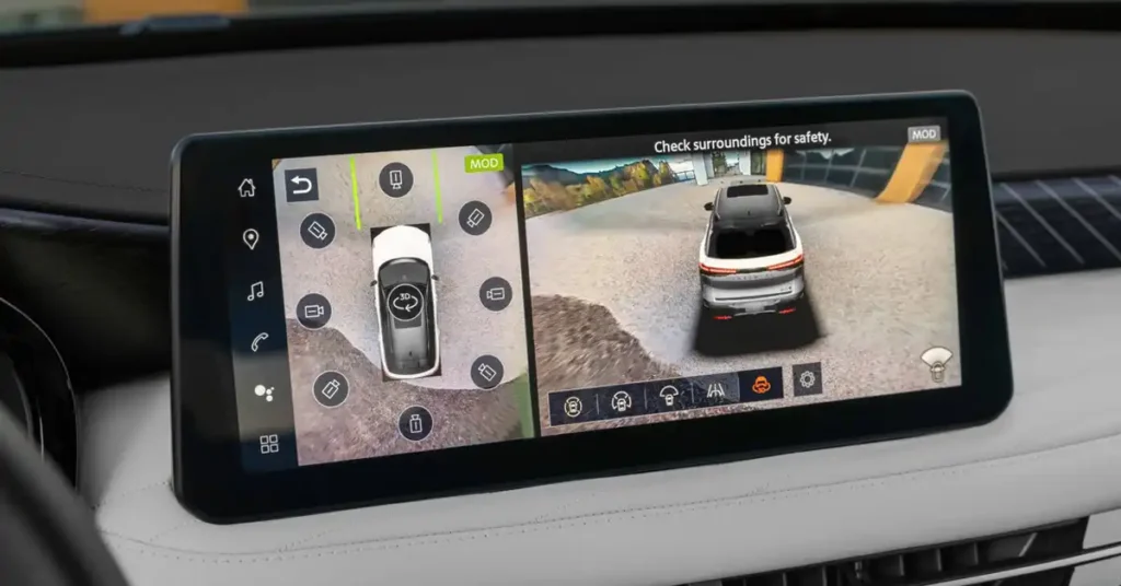 A wide, horizontal 2026 INFINITI QX60 SUV infotainment screen displays a 360-degree camera view. The left side of the screen shows a top-down view of a white car with a circular arrow indicating a 3D rotation option.