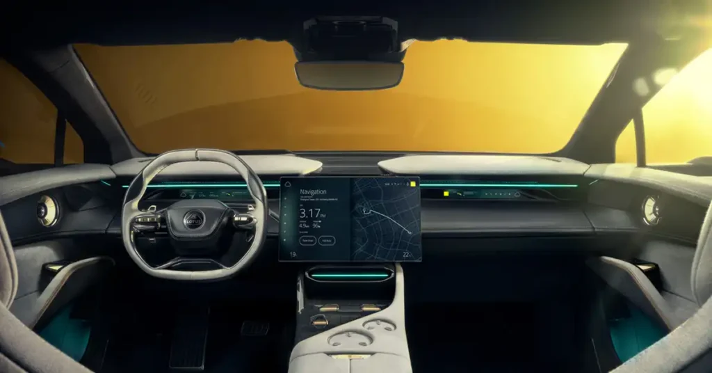 The image shows the interior of a Lotus Eletre electric SUV, viewed from the driver's perspective. The dashboard is dominated by a large, sleek touchscreen display showing navigation and vehicle information. To the left is a futuristic steering wheel with integrated controls.