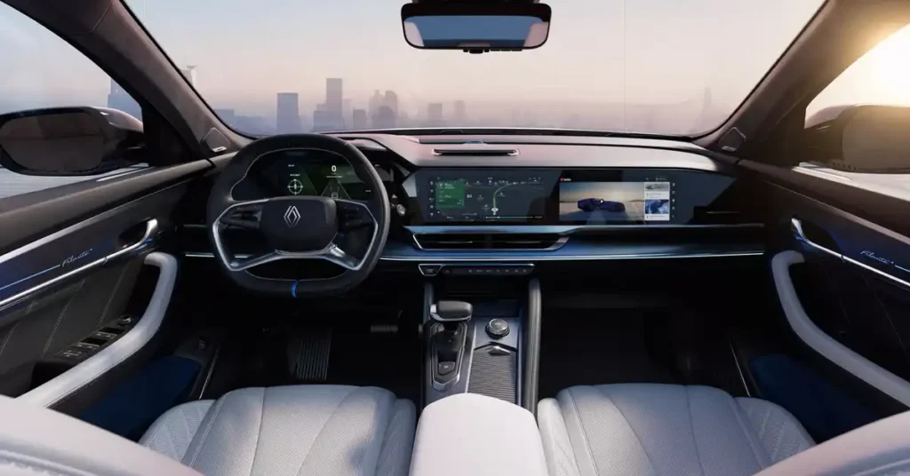 The image shows the interior of a A RENAULT FILANTE ESPRIT ALPINE SUV, viewed from the perspective of the driver's seat. The dashboard features a large, curved display screen that shows navigation and other information. To the left of the screen is a digital instrument cluster. The steering wheel is in the foreground, with a sleek design and controls. The seats are upholstered in light-colored leather.